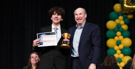 Andrew Cooper presenting 3D printed awards at Greater Austin Regional Science and Engineering Fair