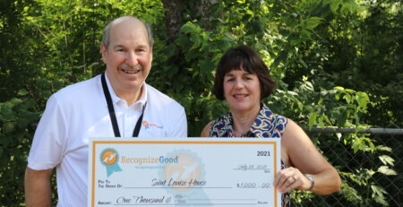 Andrew Cooper awards a RecognizeGood Legend a donation check